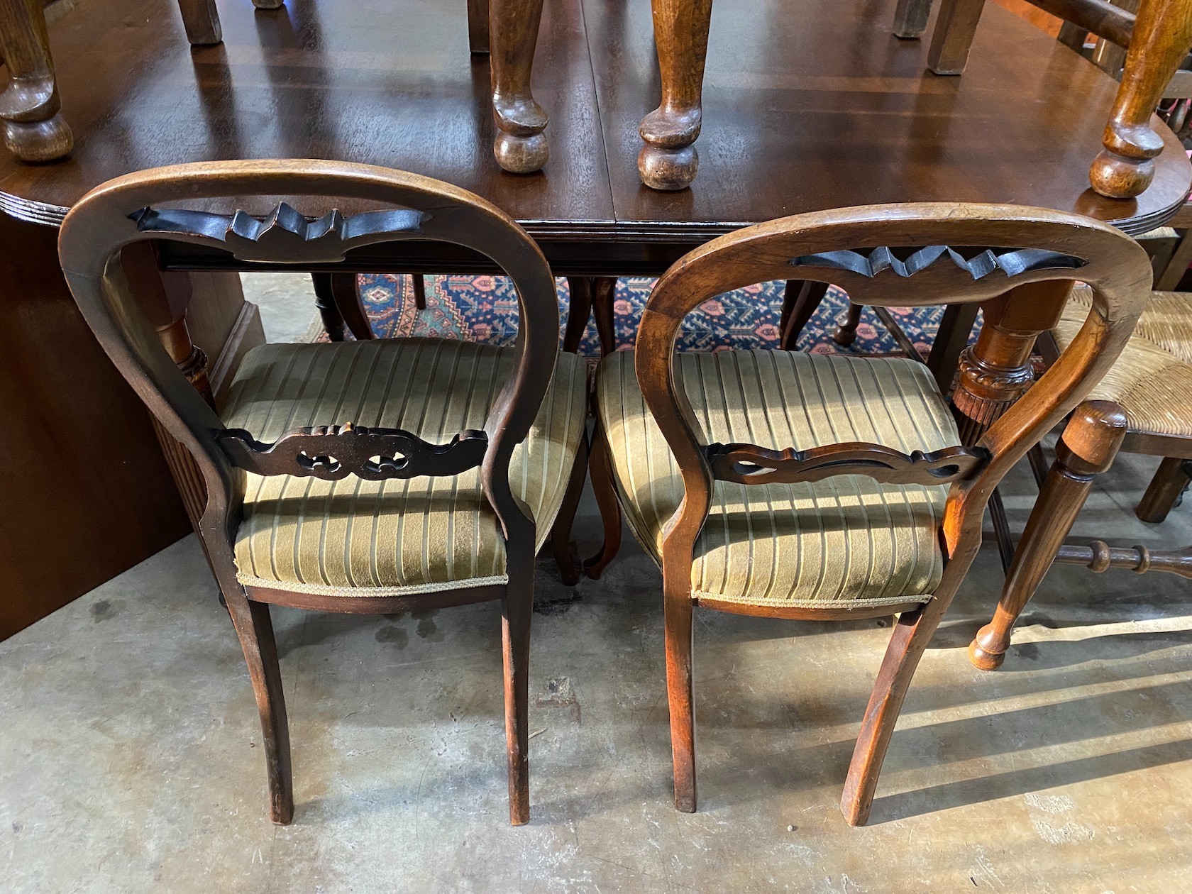 A set of four Victorian balloon back dining chairs